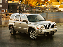 front corner view of a Jeep Liberty sitting next to a dock